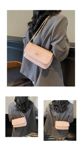 Detail of light pink quilted leather bag with gold chain strap and luxury metallic logo