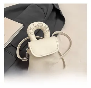 Detailed close-up of white mini handbag with HELLO embroidery and rounded handle