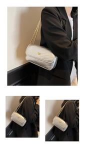 Detail of silver oil wax leather crossbody bag with V-shaped quilting and chain strap