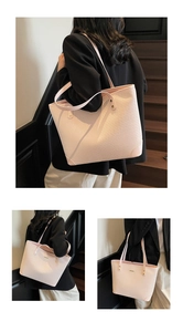 Detail of light pink tote bag featuring woven texture and reinforced leather corners