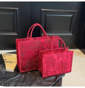Detail showing two sizes of red jacquard floral embroidery tote bags with intricate texture