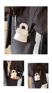 Minimalist white crossbody mini phone bag with HELLO embossed handle and long shoulder strap