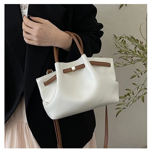 Minimalist beige leather wing tote bag with brown handles and gold hardware buckle