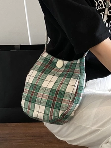Classic green and white checkered canvas crossbody bag with elegant button closure
