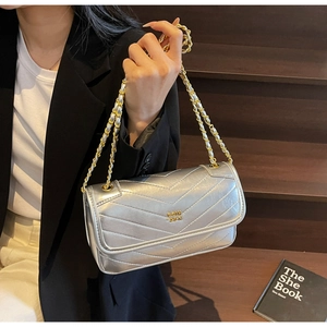 Detail of silver oil wax leather chain bag with V-quilted stitching and metallic finish