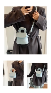 Close-up of light blue mini phone bag with padded handle and embossed lettering detail