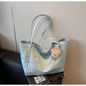 Light blue oil-wax tote bag with pleated texture and cute brown plush bear pendant