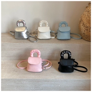 Detailed view of five colorful mini PU leather crossbody bags with HELLHE embroidery detail