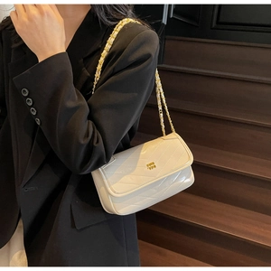 Detail of off-white chevron quilted bag with gold chain strap and metal logo