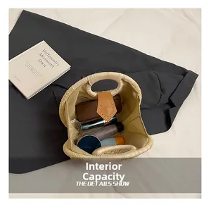 Internal capacity of the straw woven bag showing space for phone and cosmetics