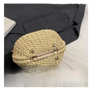 Close-up of durable metal studs and hinges on the bottom of a straw woven handbag