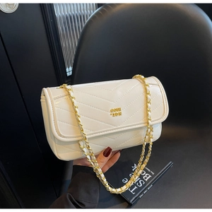 Close-up of white V-quilted faux leather crossbody bag with elegant gold chain strap