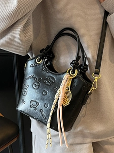 Fashionable black embossed bucket bag with cartoon bear and heart patterns and tennis charm