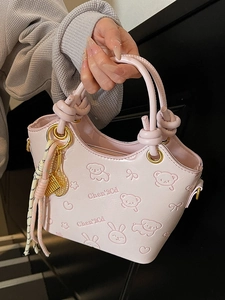Pink embossed bucket bag with cartoon patterns and gold racket charm for women