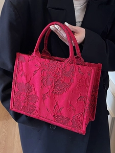 Elegant red bridal tote bag featuring intricate floral embossed embroidery for weddings