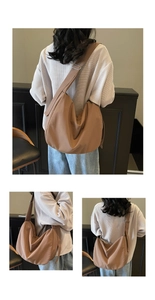 Detail view of large brown canvas crescent bag with adjustable wide shoulder strap