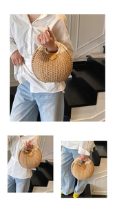Detail of round straw bag showing the handwoven texture, leather trim, and metal feet studs