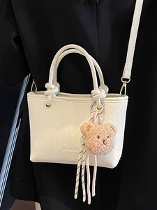 Minimalist white woven bucket bag for women with cute plush bear pendant accessory
