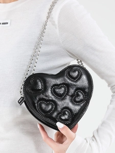 Chic black heart-shaped crossbody bag with embossed heart motifs and silver ball chain
