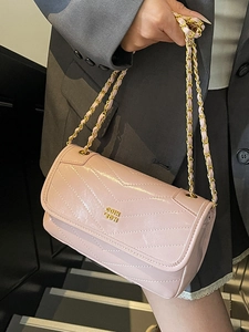 Pink V-quilted faux leather chain bag for women worn with grey blazer casual outfit