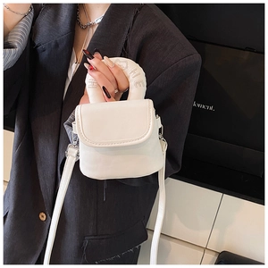 Close-up of white mini crossbody bag with embroidered cat motif on padded handle