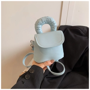 Detail view of light blue mini crossbody bag featuring a padded handle with HELLO embroidery