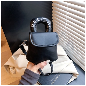 Detail of black leather mini crossbody bag with HELLO embroidered circular handle