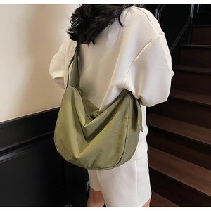 Detailed side view of the large grass green Hobo tote bag showing its water-resistant nylon texture