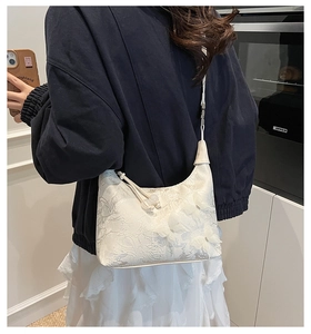 Detailed embroidery texture and 3D butterfly ornaments on a cream jacquard bag