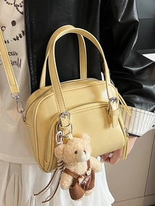 Pale yellow small Boston pillow bag in oil wax leather with cute plush bear charm