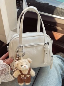 Chic white oil wax leather crossbody pillow bag with a cute plush bear pendant