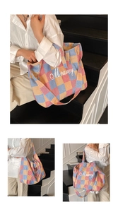 Detail of colorful checkered woven tote bag with Mearey embroidery on high-quality fabric