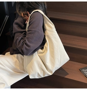 Off-white large capacity tote bag shown on model for casual everyday style
