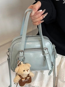 Light blue oil wax leather pillow bag with cute bear charm and adjustable strap