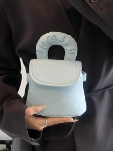 Minimalist light blue mini handbag with embossed cat handle and flap cover design