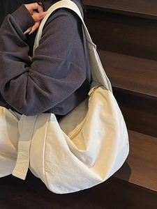 Minimalist beige oversized crescent tote bag made of soft nylon for daily casual commuting