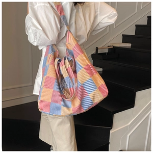 Detailed view of oversized colorful checkered canvas tote bag with embroidery details