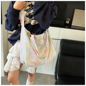Detailed view of the colorful plaid tote bag made of waffle texture canvas material