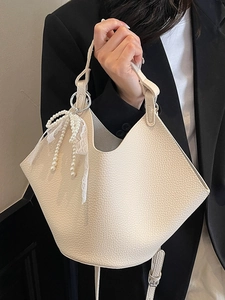 Elegant cream white lychee grain bucket bag with pearl lace bow detail and slim strap