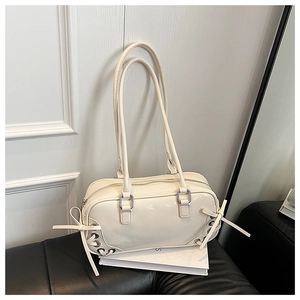 Dettaglio della borsa avorio con occhielli laterali e fiocchi decorativi stile balletto
