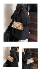 Detail of colorful rainbow straw woven crossbody bag with brown leather envelope flap