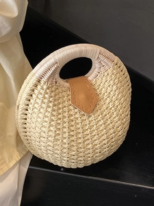 Handcrafted round straw woven handbag with leather closure for summer beach vacations