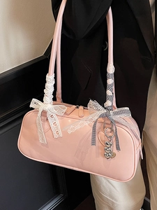 Pink patent leather underarm Boston bag with lace ribbon and heart pendant detail