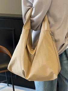 Minimalist khaki nylon hobo tote bag with a slouchy crescent shape and large capacity