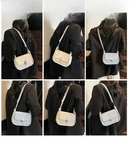 Minimalist square flap crossbody bag with metal rotary lock shown in white and blue