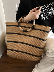 Large capacity straw woven beach tote bag with black stripes and circular handles