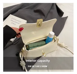 Detailed view of the internal capacity showing dual compartments of the white baguette bag