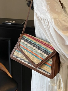 Rainbow woven straw crossbody bag with brown leather trim and envelope flap closure