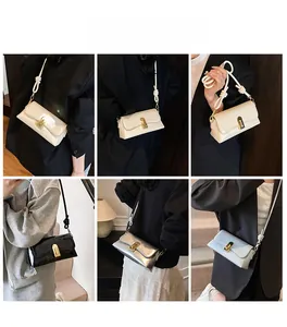 Detail view of stylish square crossbody bags with metallic locks and knot strap accents