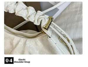 Close-up of white snake pattern leather bag with elastic pleated shoulder strap detail